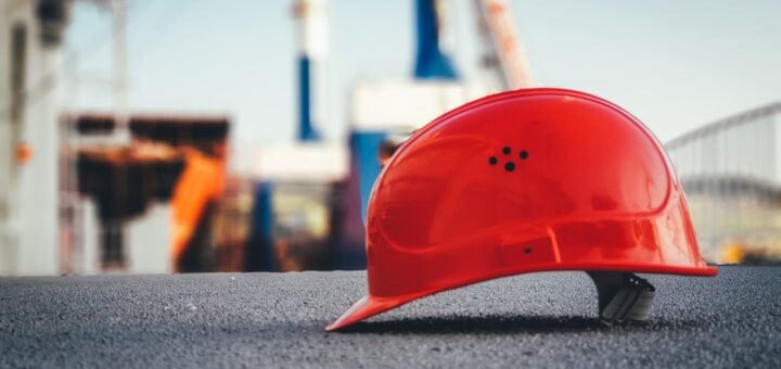 red hard hat on pavement